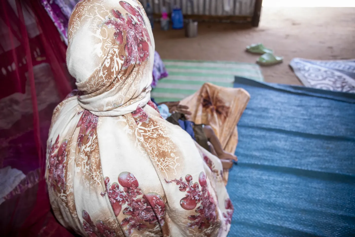 Halima and baby Mohamed inside their home in Dadaab Refugee Camp