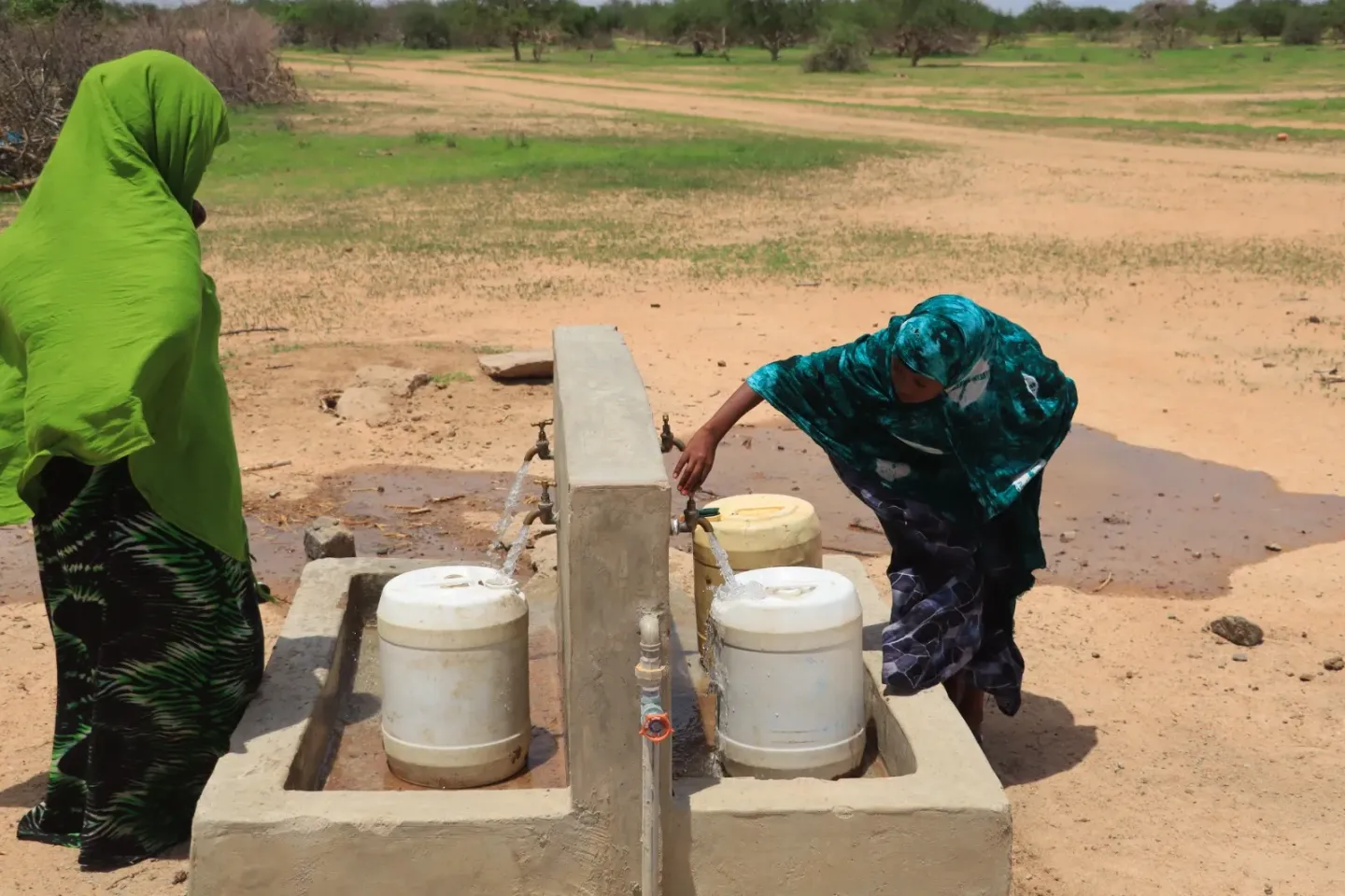 A woman and her child fetch water in Gunjiya village, Garissa