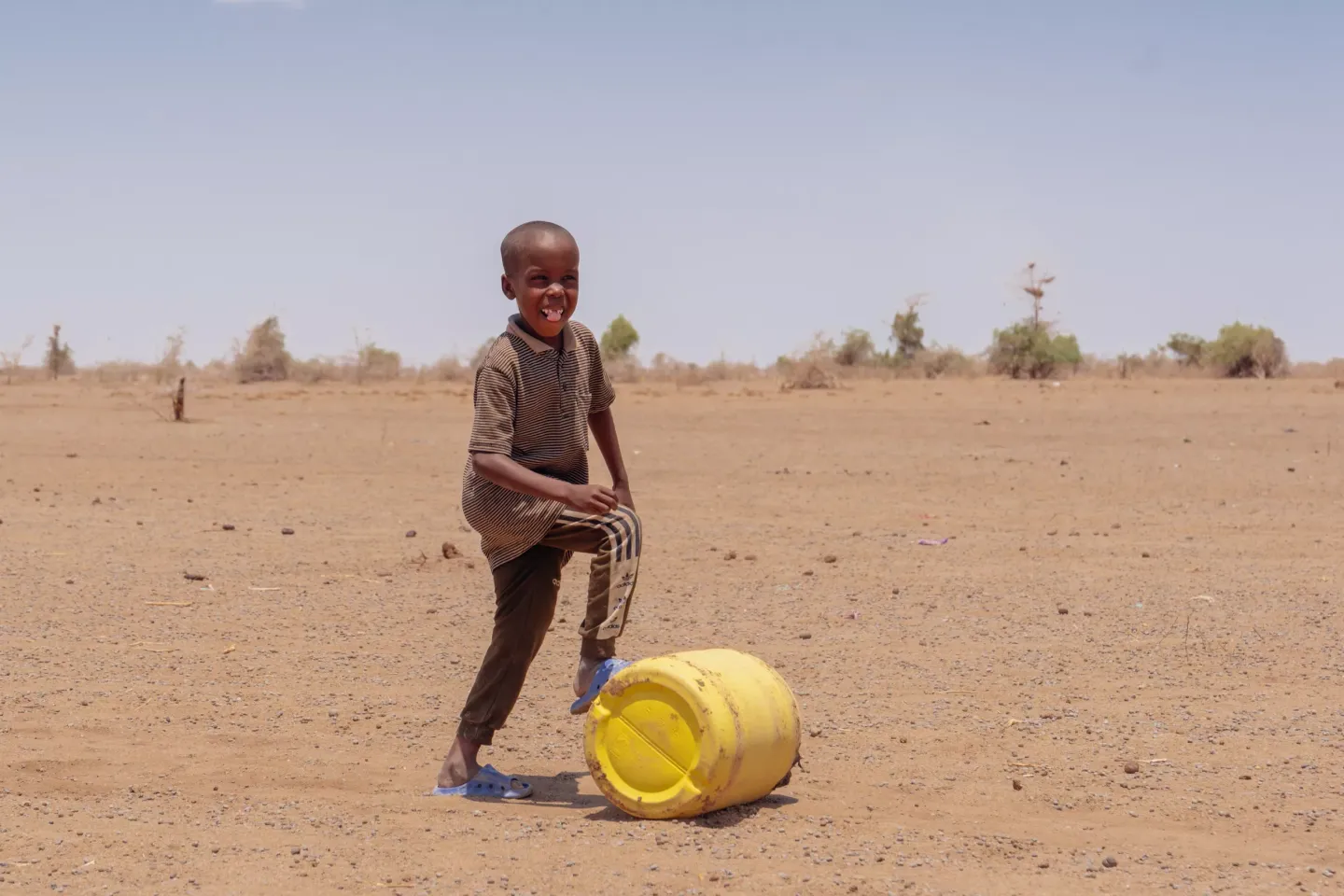 A child rolls a jerrycan in Garissa 