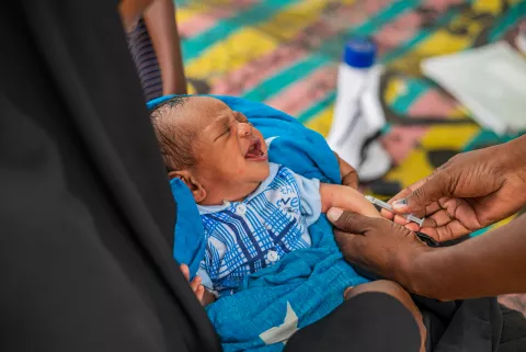 A baby gets vaccinated in Wajir County