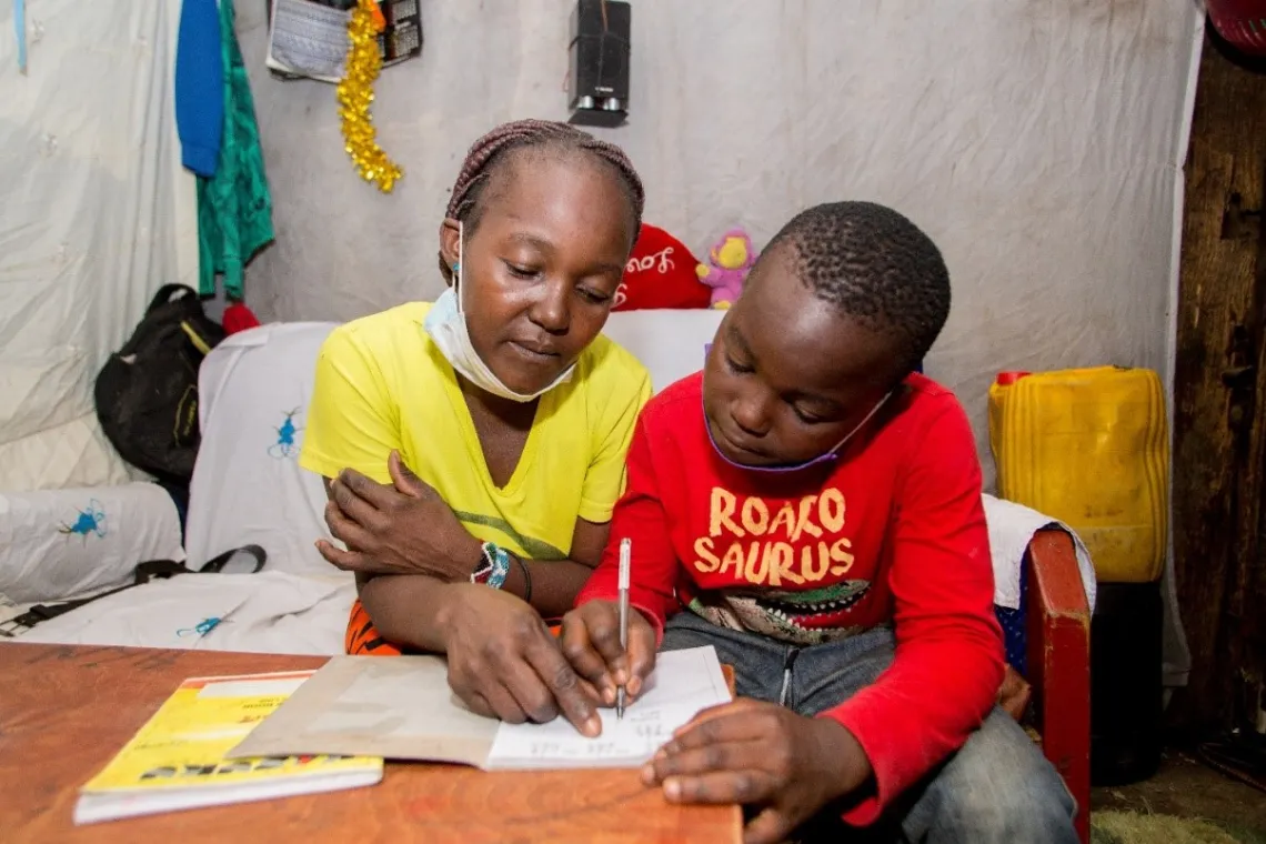 Brian Mose is home schooled by his mum Gladys