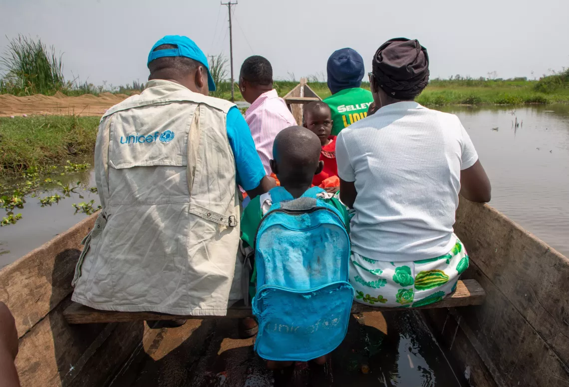 UNICEF Kenya Education Officer Stanley Akine crossing by boat to Nduru Primary School, Kisumu County.