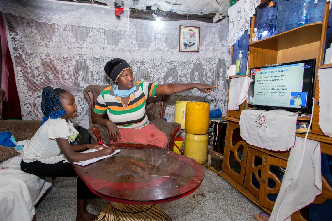 Precious is home-schooled by her mum