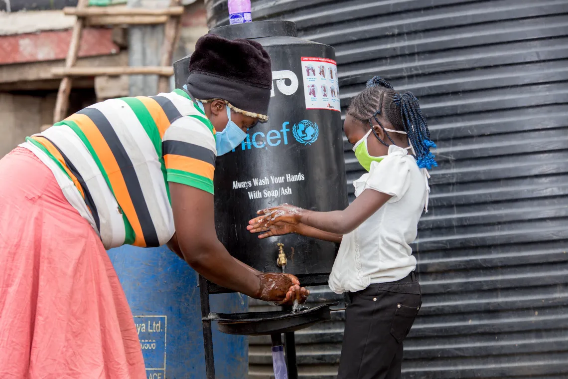 Mary and Precious wash their hands