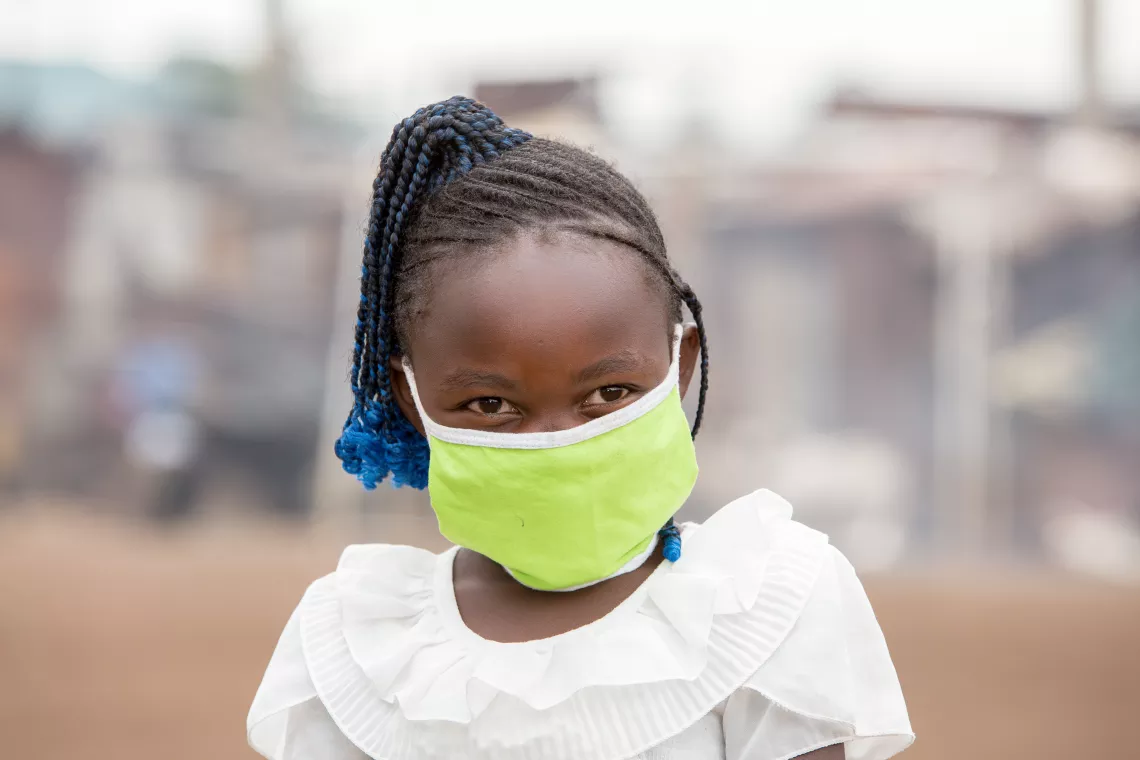 Precious wears a cloth mask