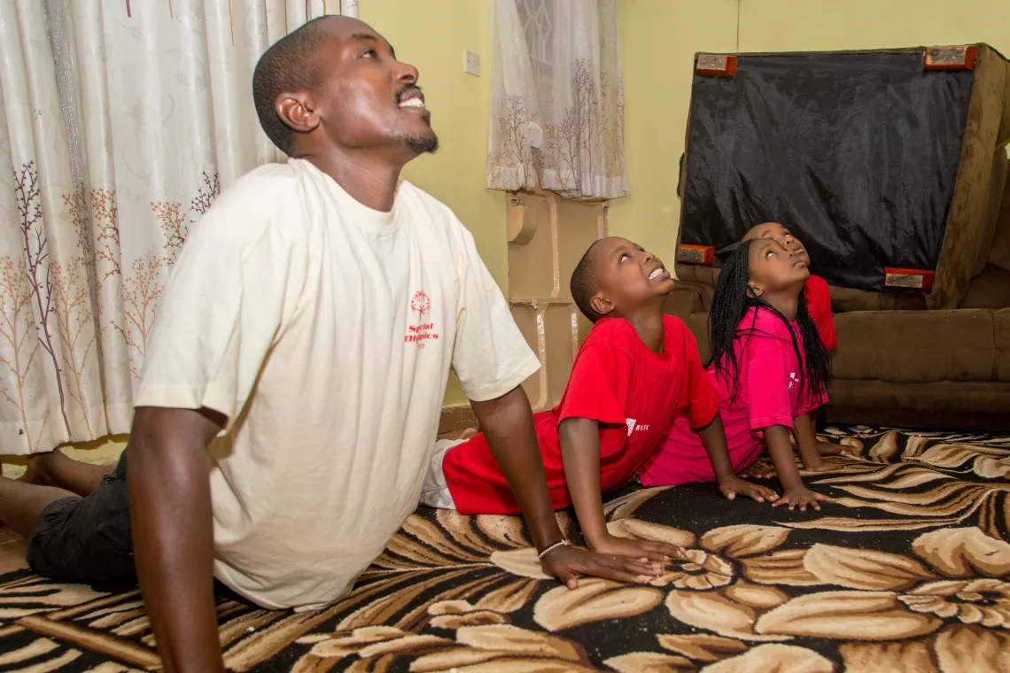 Buxton exercises at home with his siblings.