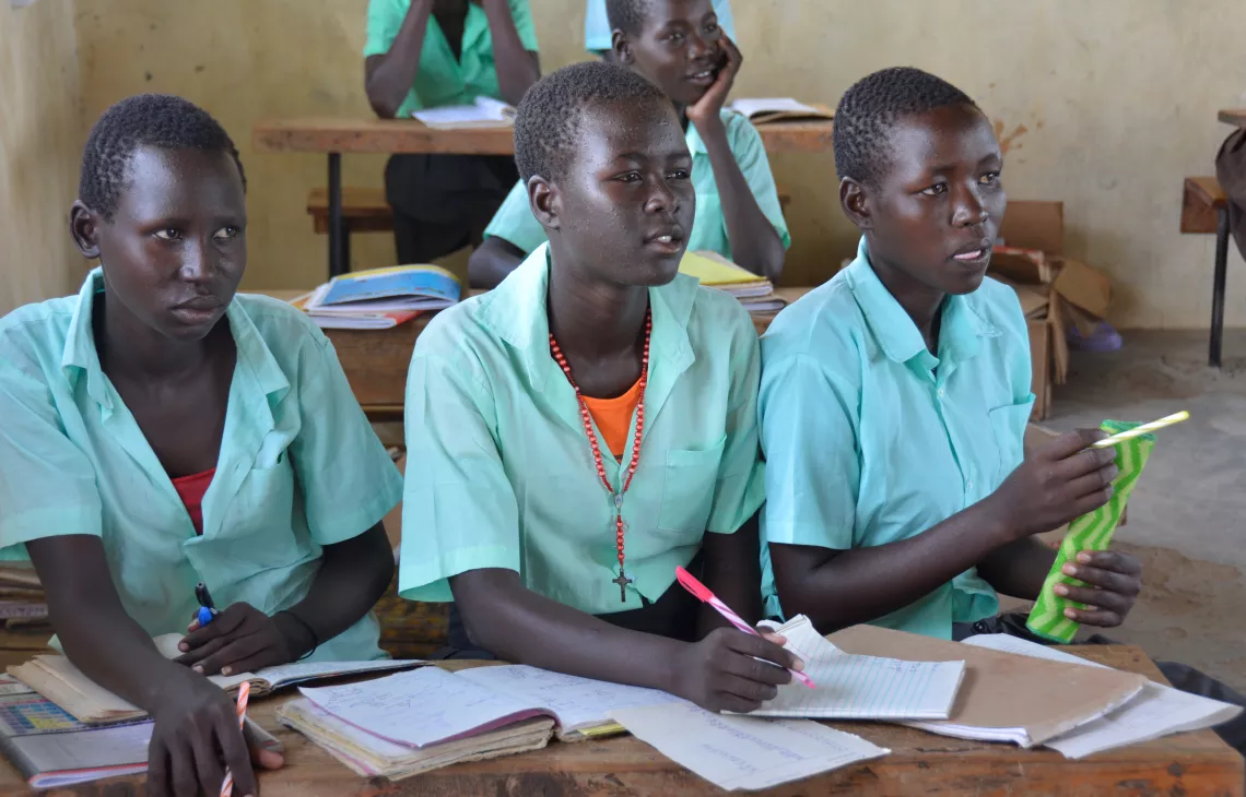 Irene (centre) learns maths at Naipa Primary School. She left when there was no water.