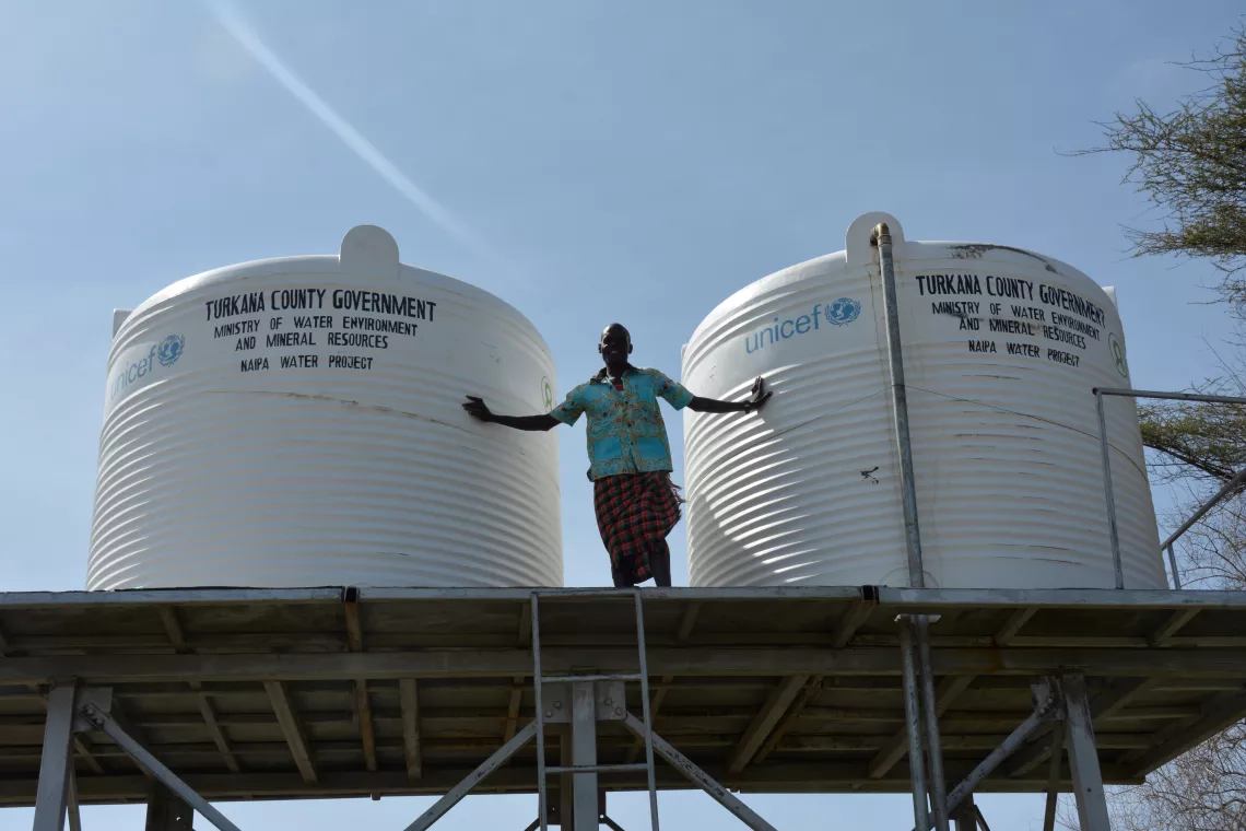 James demonstrates the two main tanks, where water is stored after being pumped out of the ground
