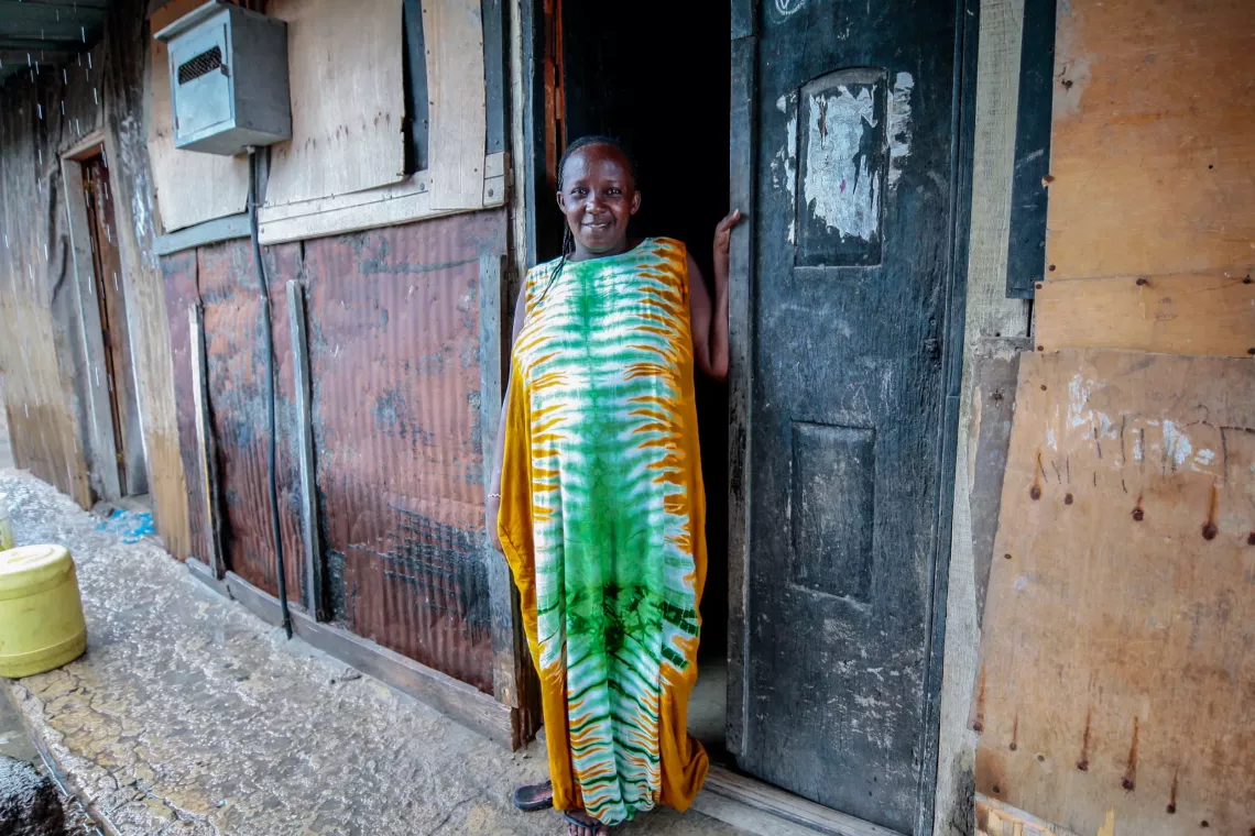 Tina Mula stands outside her house 