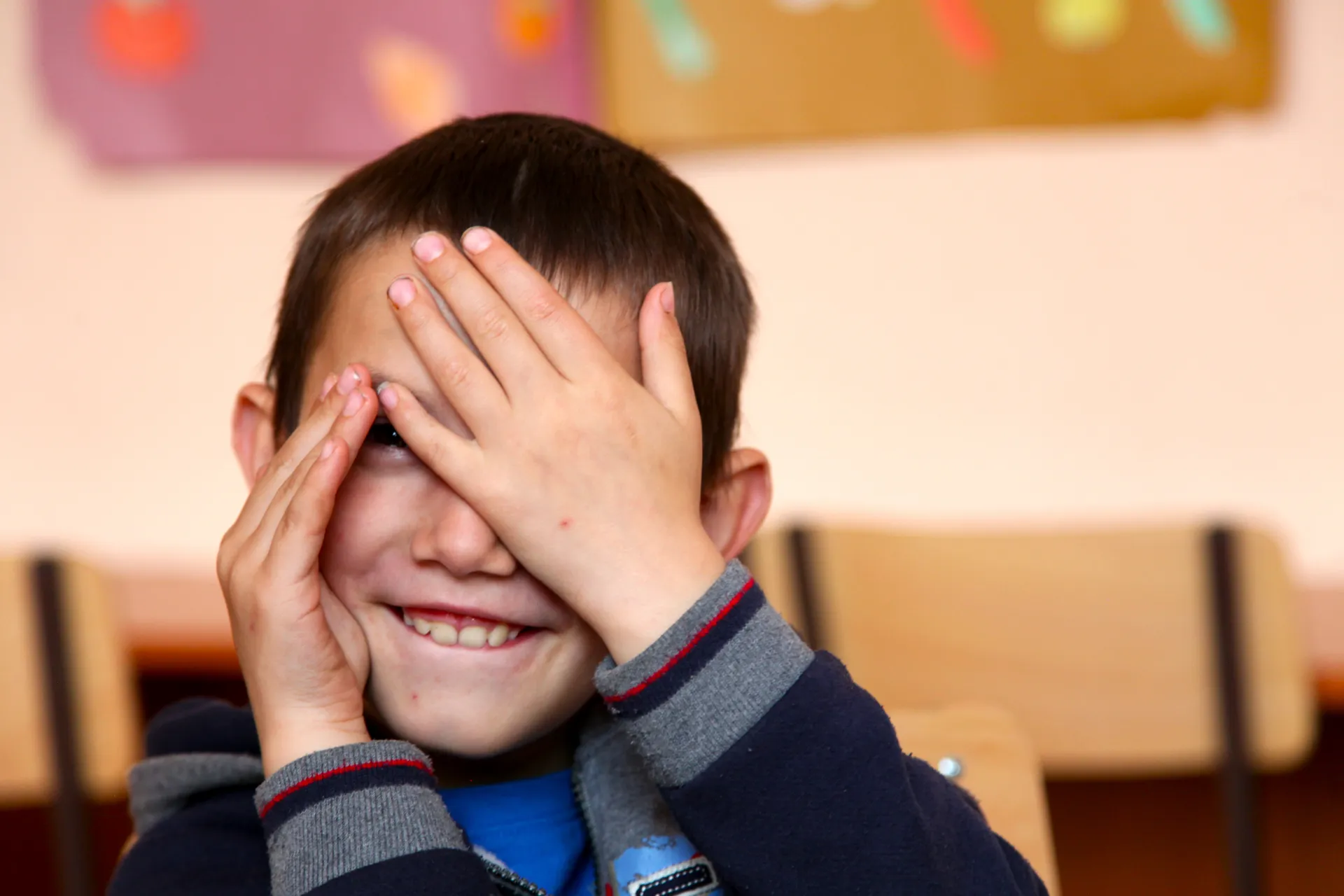 A boy with autism plays &lsquo;peek-a-boo&rsquo; in a class.