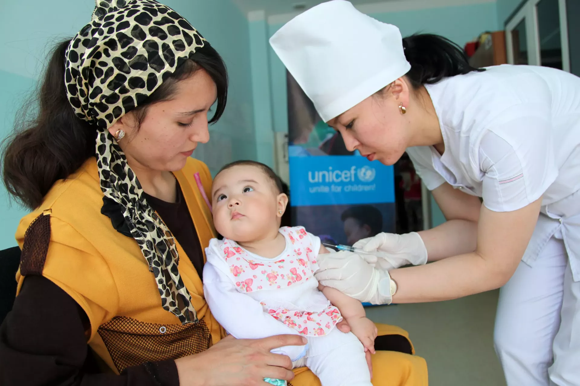 a baby getting a shot of vaccine
