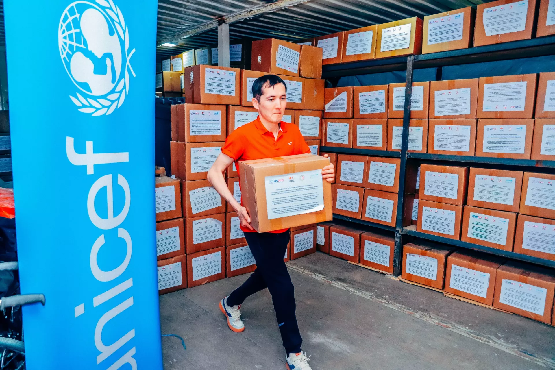 a person loading boxes with supplies