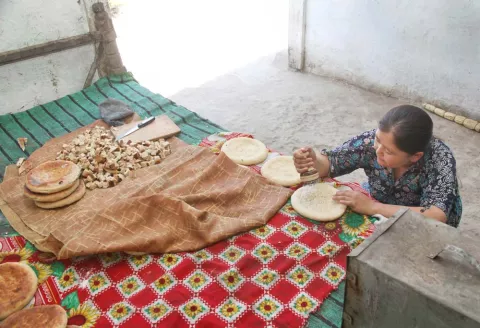 One of Momina’s daughters is preparing naan. Conditions are simple; this family is officially categorized as one in a difficult life situation.