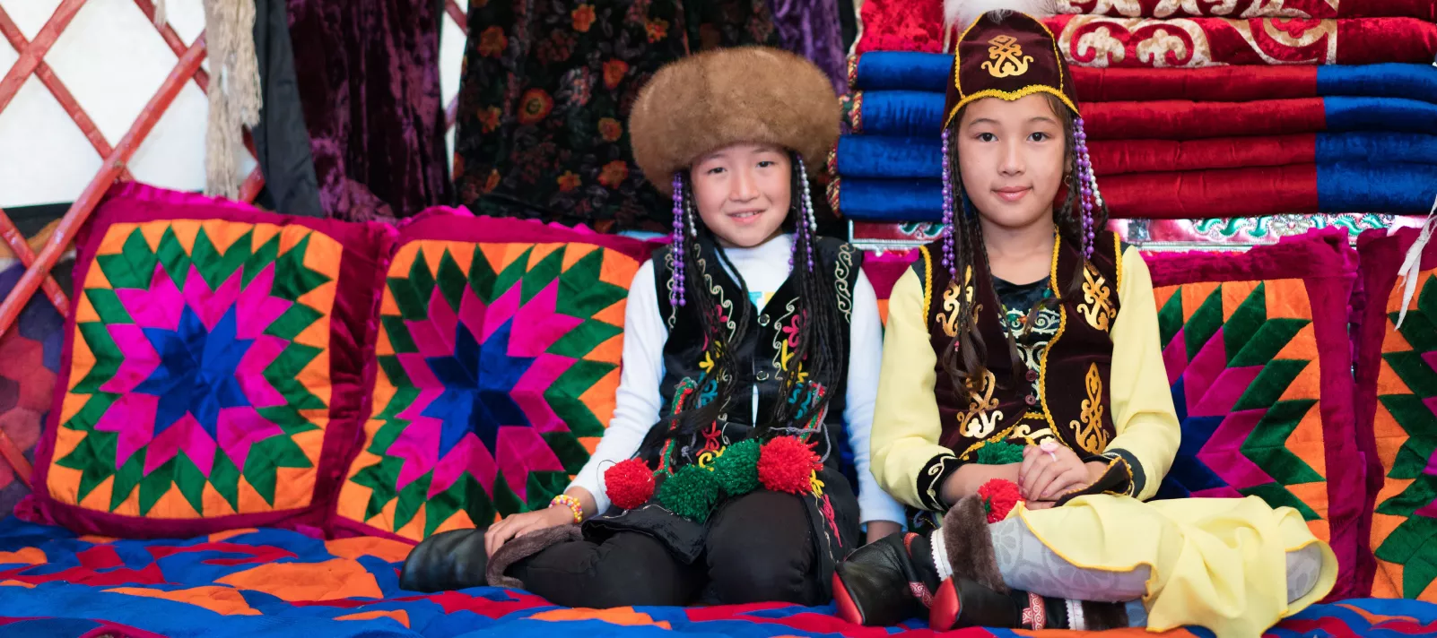Girls sit in national costumes in Kyrgyzstan