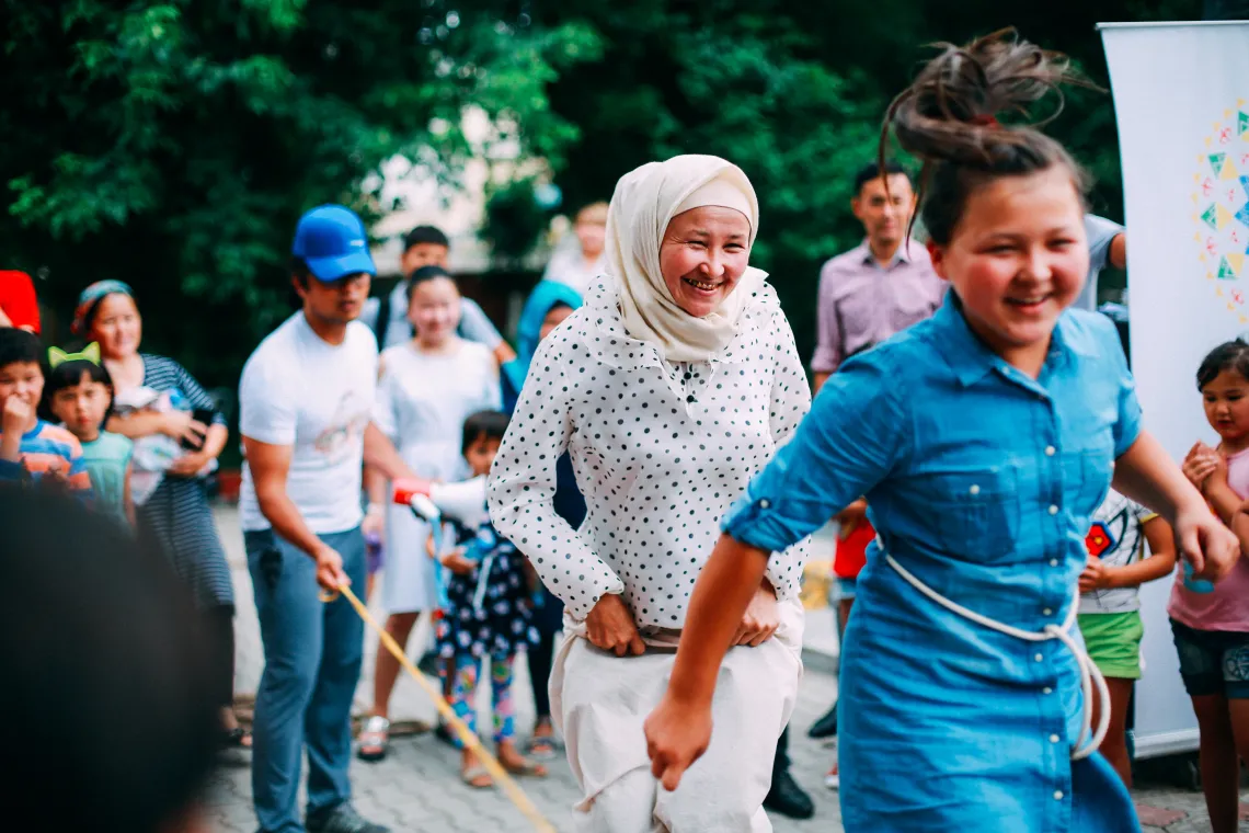 a mother with her adolescent daughter play together