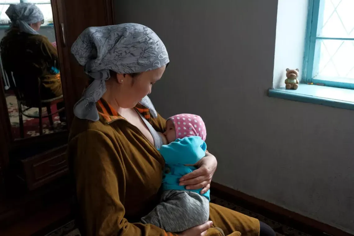 a mom is breastfeeding her child
