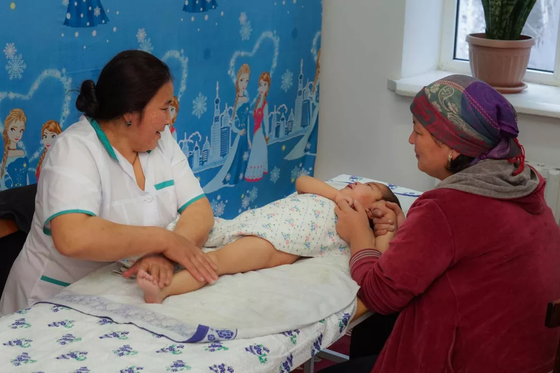 Children with cerebral palsy often have high muscle tone. Massage therapy, as provided here by Razgul Bektemgova, eases muscle tension and improves mobility.