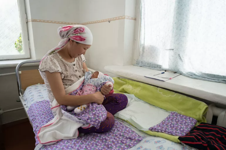 a mother holds her newborn
