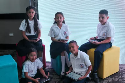 Group of students holding their tablets