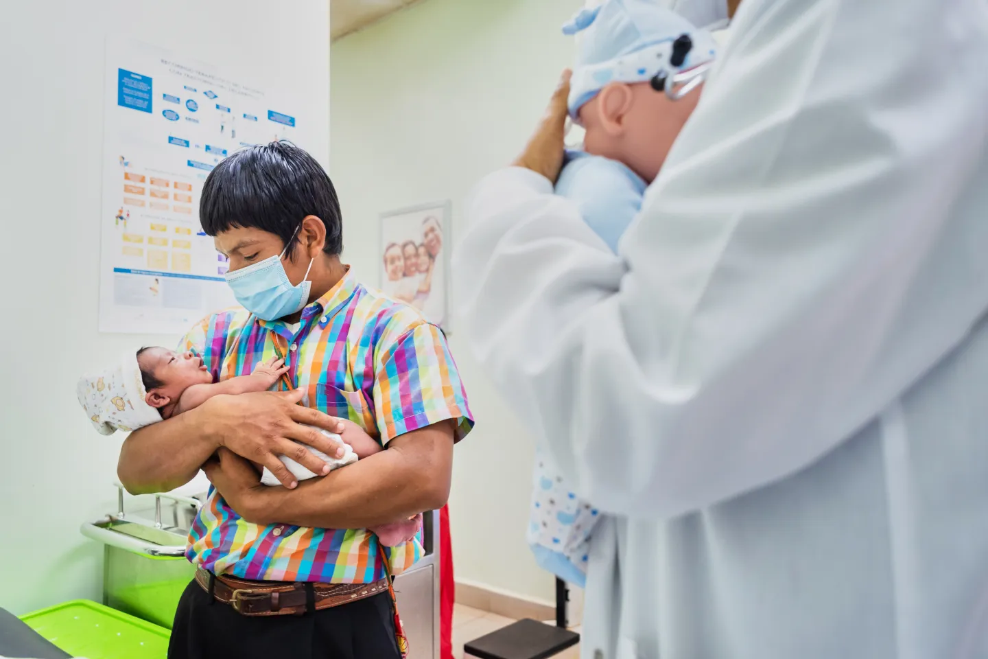 Ocu, Panama, June 2021. A father receives counseling during a routine check-up with the pediatrician. Doctor Cornelia Thomas counsels the famliy on Care for child Development (CCD), a program implemented by UNICEF in Latin America and the Caribbean.
