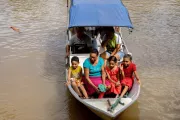 Community health workers traveling by boat to reach families.
