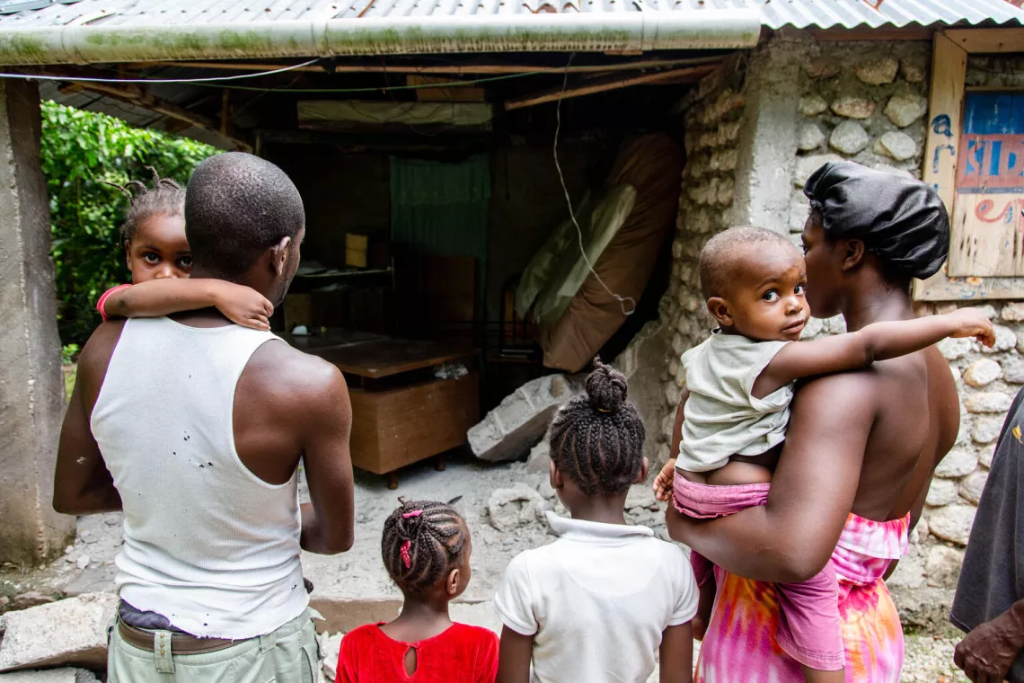 Pierre Wilhton (left) and his family in front of home that was damaged during the earthquake, in the Capicot area in Camp-Perrin in Haiti&rsquo;s South Department.