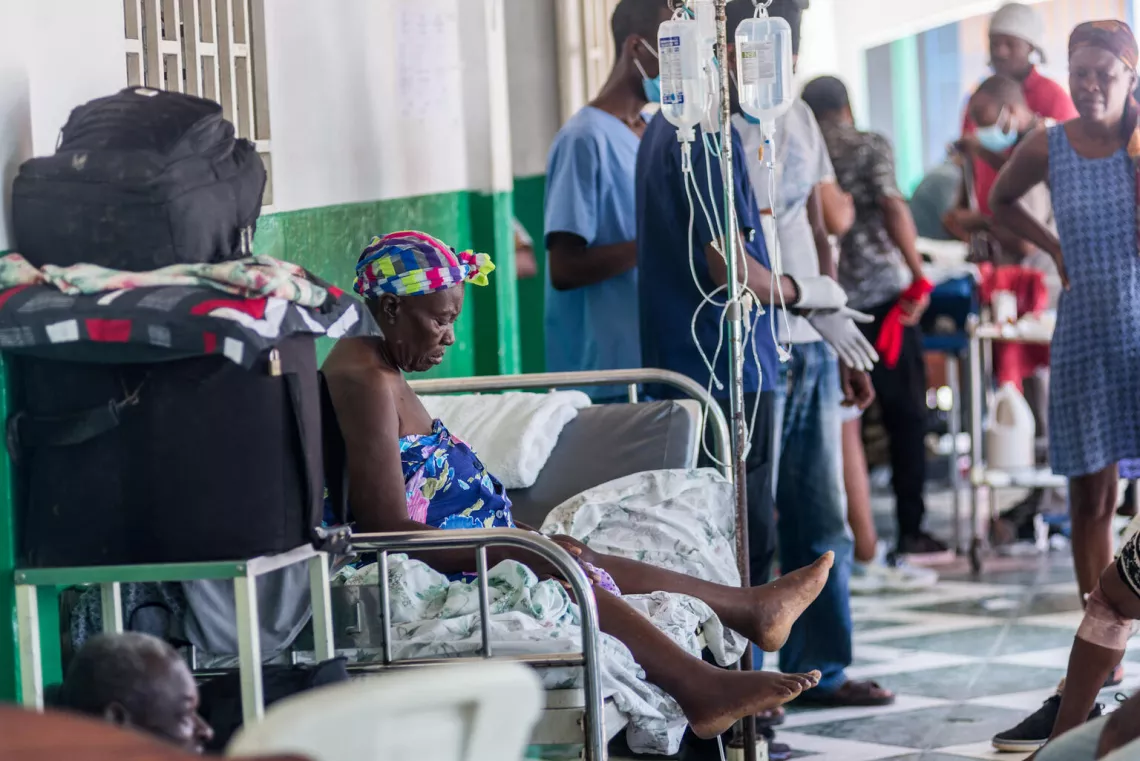 An injured woman rests on a bed at a hospital in Les Cayes on August 15, 2021.