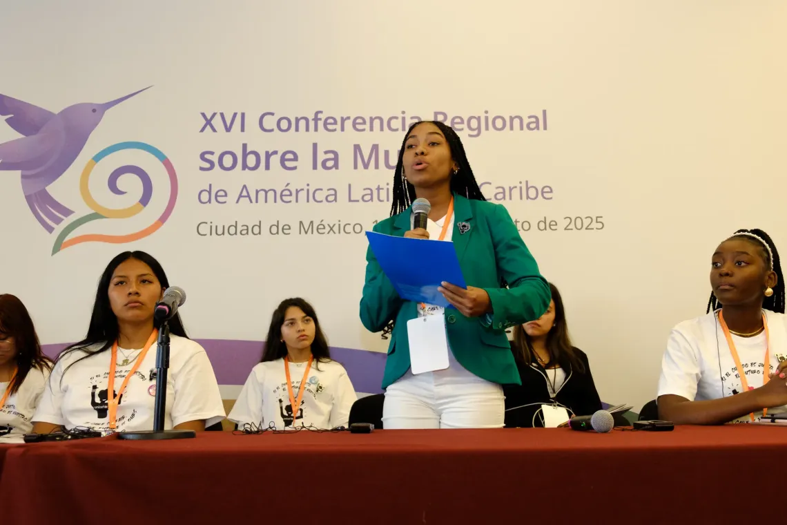 A young woman speaks at a regional conference on women 