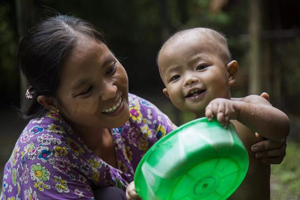Daw Nyo Nyo Aye bathes her daughter Kyal Zin Naing (10 months) at her home, Lay Bway Chaung Village, Kan Gyi Daunt township, Irrawaddy region, Myanmar.