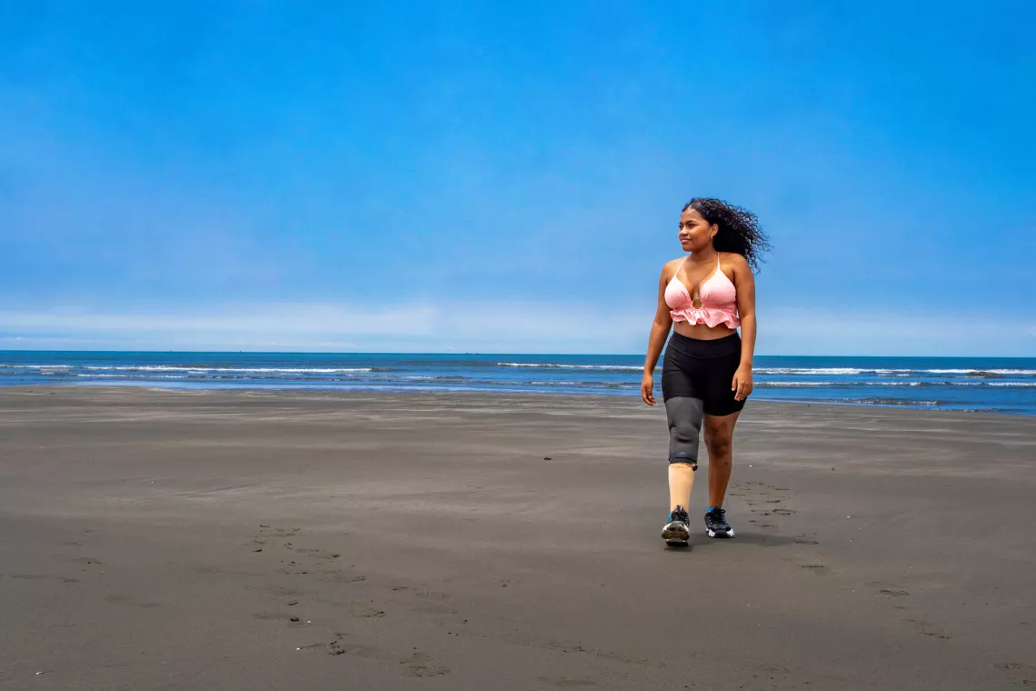 Maribel walks on the beach
