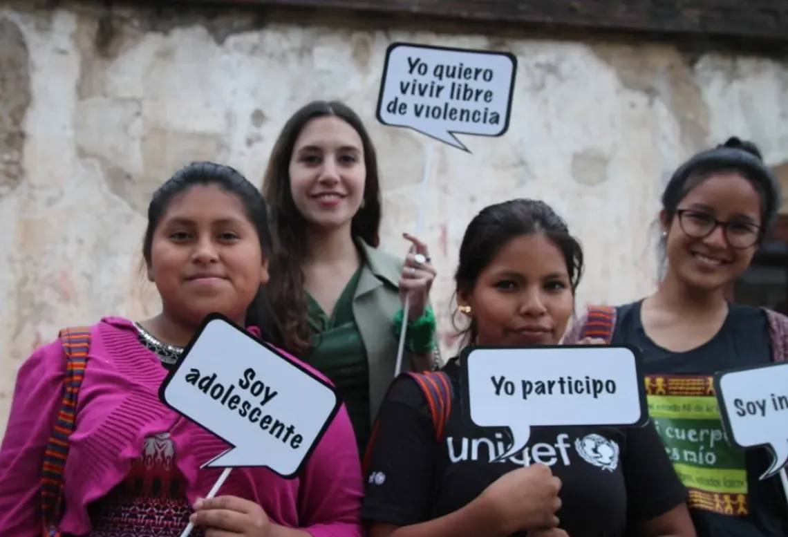 A group of young women holding signs
