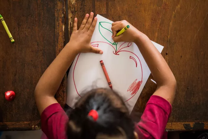 A girl drawing an apple