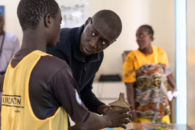 Lame speaks with a child while visiting the Samu Social shelter for at-risk street children in Dakar, Senegal. 
