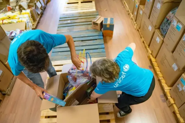 UNICEF workers pack supplies in boxes