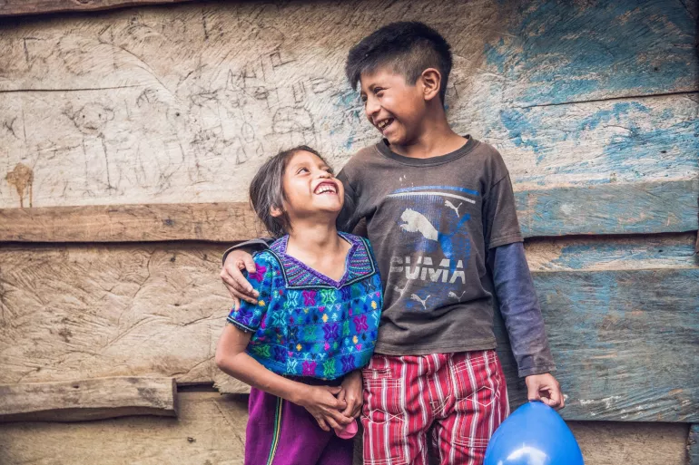Maynor Federico Ahil&oacute;n Ram&iacute;rez (9 years old) and Yury Elidia Ahil&oacute;n Ram&iacute;rez (7 years old) from the indigenous community of Todos los Santos, Huehuetenango, smiling outside their home.