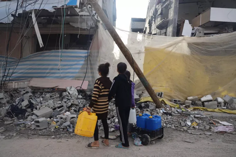 Children collecting water in Khan Younis city, south of the Gaza Strip, amid escalating hostilities. 