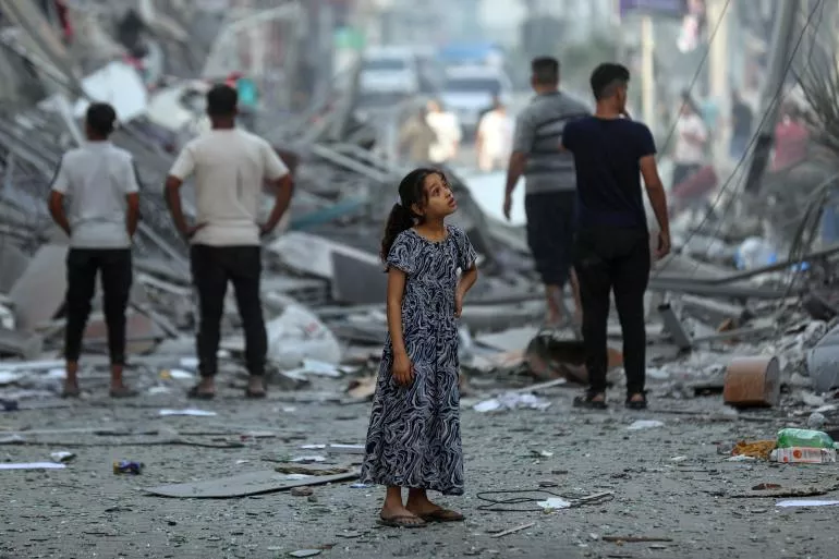 Amal, 7 years old, contemplates her neighbourhood after neighbouring homes were levelled to the ground