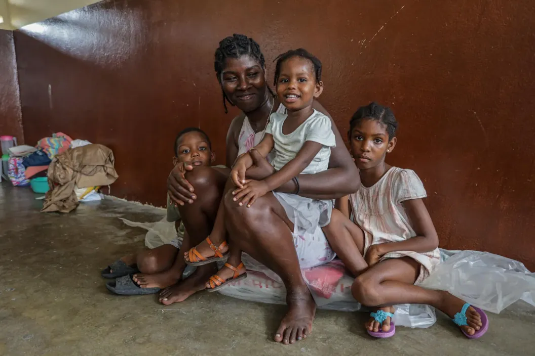 Bienvil Bettie, 25, and her three children pose for a portrait. They are taking refuge at a school after their home was damaged by Hurricane Melissa.