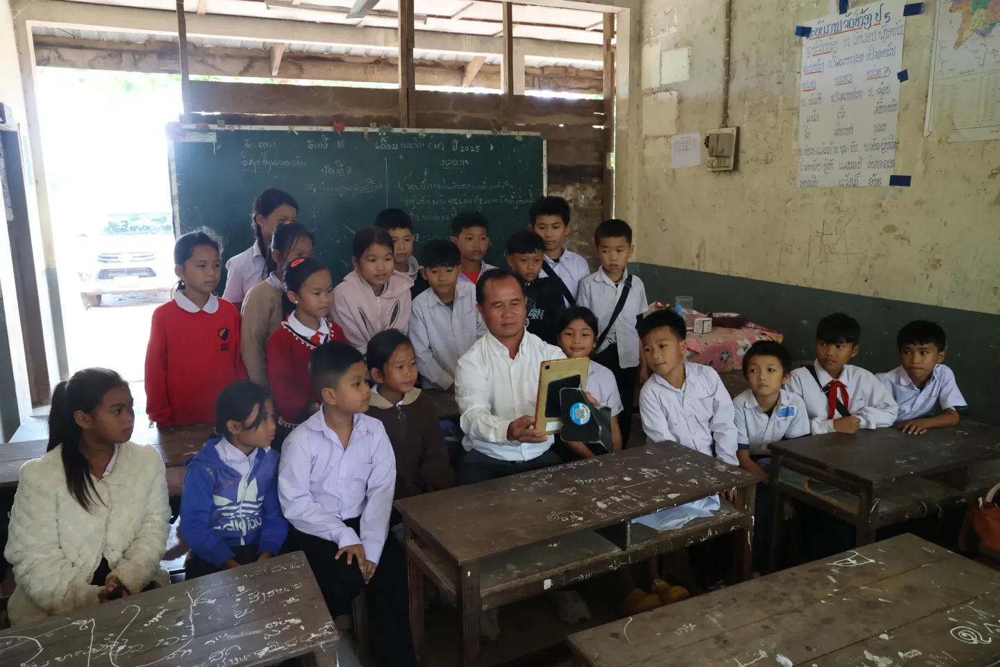 Mr. Phonxay showing tablet for education to his students
