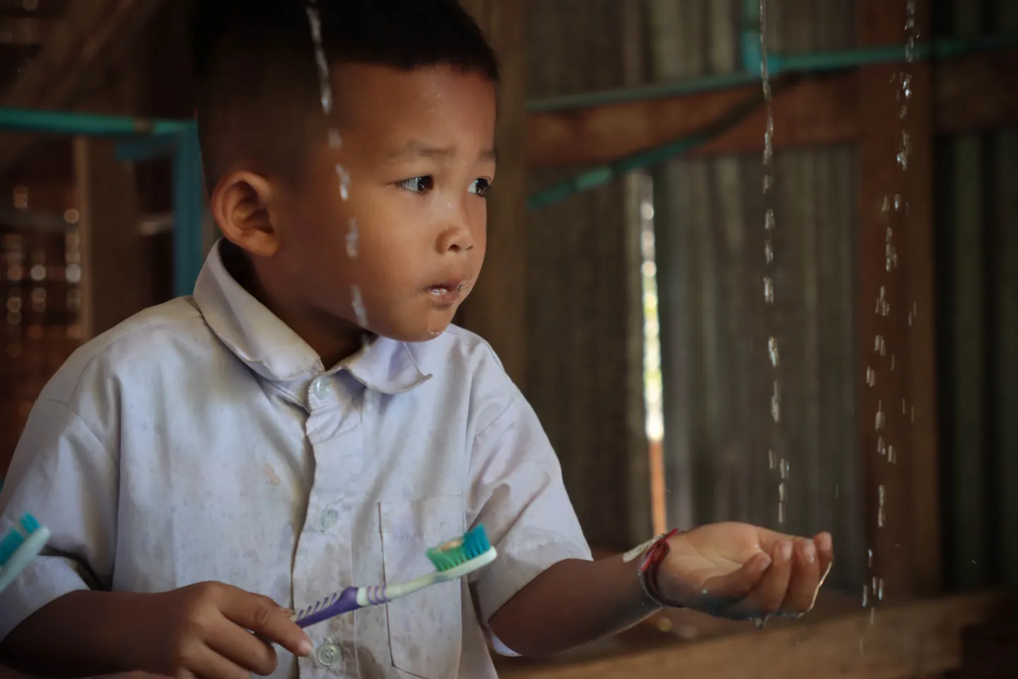 A pre-primary student at Keng Kou Primary School brushes his teeth.