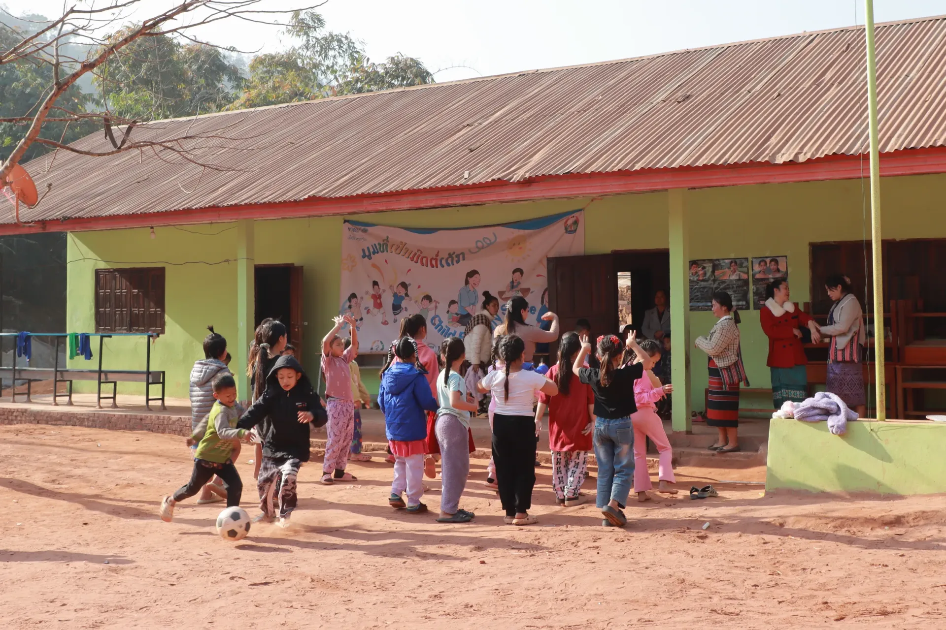 Children running from the playground into school building