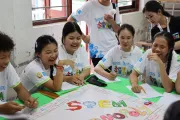 Laughter and learning combine as students enjoy a collaborative STEM activity.