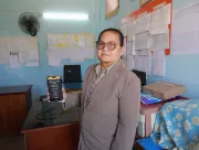 A teacher shows the air quality monitoring levels at her school to the camera.