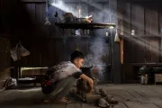 Koun, 14, Xieng Khouang Province, Lao PDR, tends the wood-fire stove to cook the family&rsquo;s meal at home.