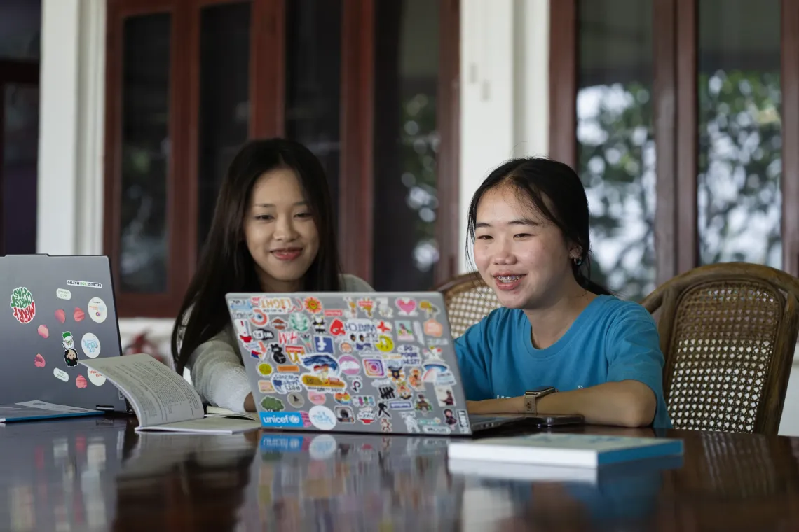 Sandy (left) and Chanphone (right) working together in the UNICEF Lao PDR office and in the field.