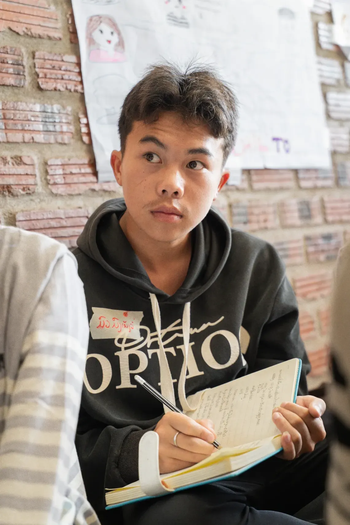 Moarmong, 16, taking notes during the training related to child marriage.