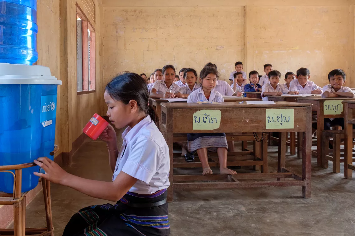 11-year-old Poun drinking filtered water in her classroom at Doub primary school