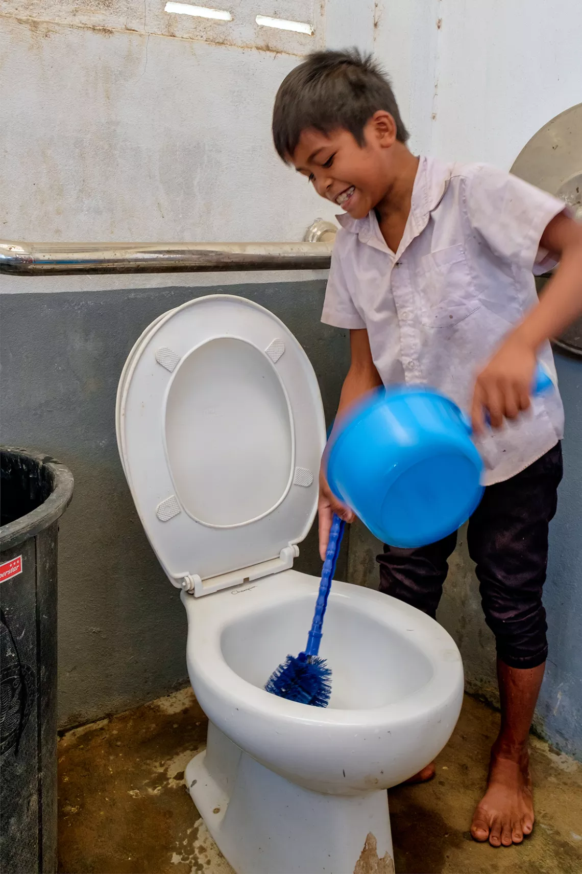 As part of Hygiene Actions led by Pupils in Schools (HAPiS) Toh is cleaning one of the toilets at his school.
