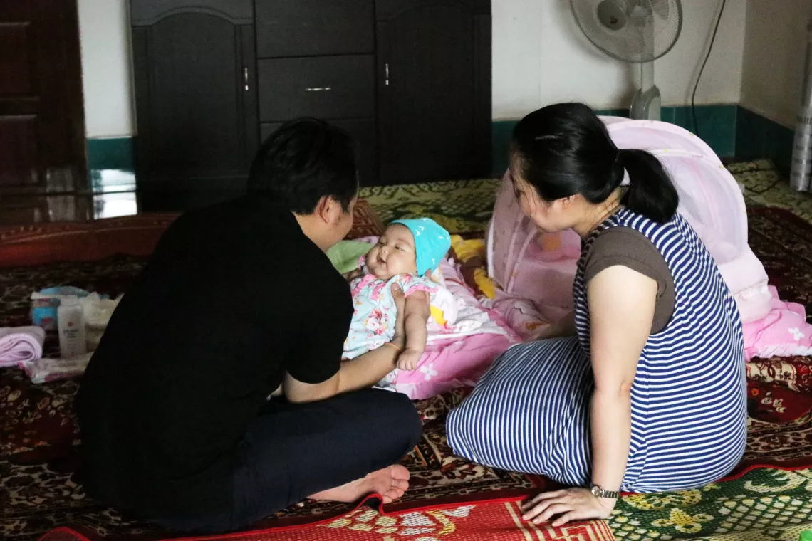 Khounkham Seebounhouang (Accounting & Finance officer at UNICEF Lao PDR) is playing with his daughter