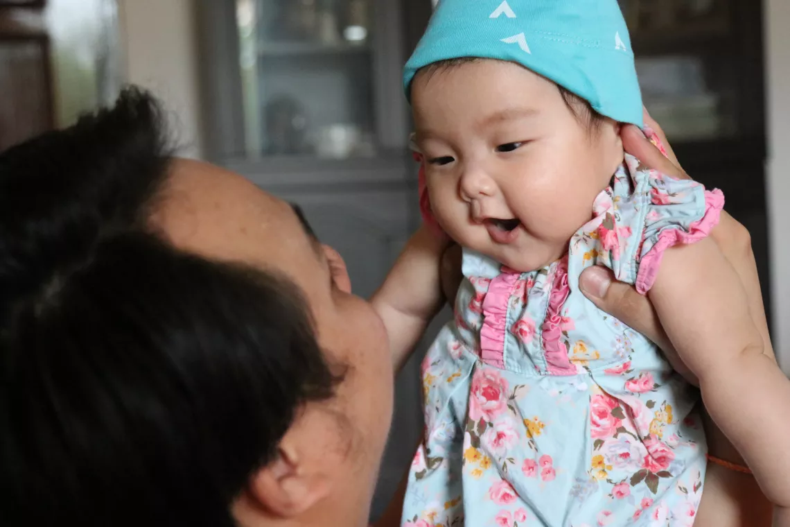 Khounkham Seebounhouang (Accounting & Finance officer at UNICEF Lao PDR) is playing with his daughter